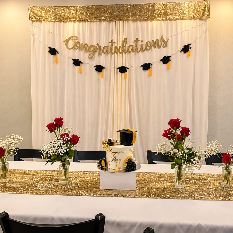 Graduation celebration with a cake, red roses, and gold decorations at Kabob Cafe & Grill.